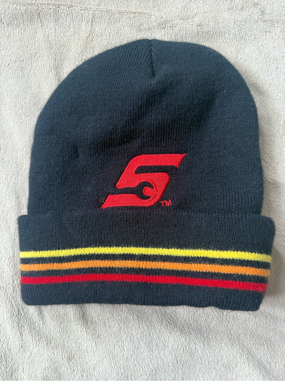 Black Beanie with Red 'S' Logo and Yellow/Red Stripe Detail